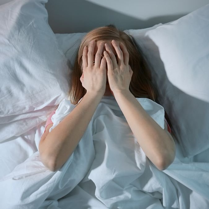 Mulher com insônia por excesso de cortisol no organismo.